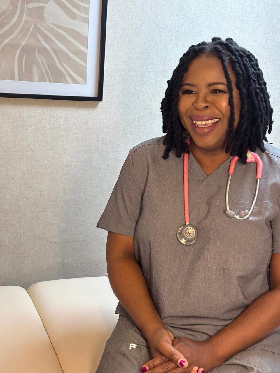 Prof. Carol Hlela in clinical scrubs